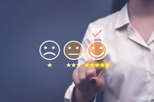 Person selecting by keeping fingers on 5 star Smiley Survey ratings.