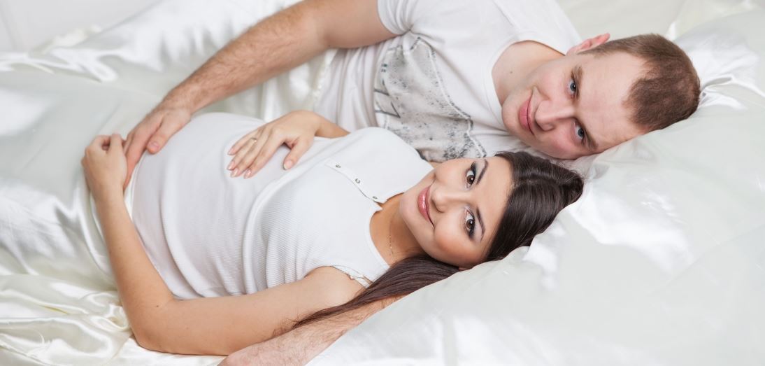 Couple embracing baby bump